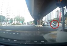 Woman, 50, Sent to Hospital After Car Hits Her at Clementi Junction Dashcam still of a pedestrian with an umbrella crossing a Clementi junction
