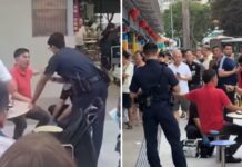 Man Who Attacked Ex-Actor Huang Yiliang Gets 12-Month Conditional Warning Huang Yiliang in a red polo shirt speaking with police at Circuit Road Hawker Centre after the assault