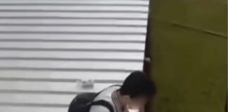 Hua Yi Secondary student sitting on a temporary metal walkway roof