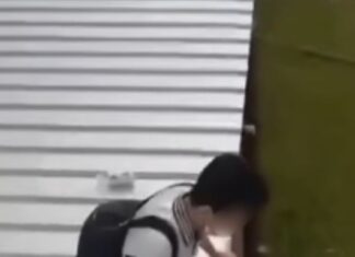 Hua Yi Secondary student sitting on a temporary metal walkway roof