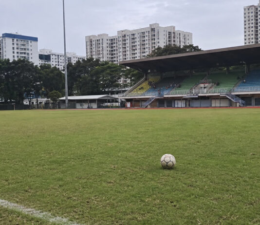 Keisuke Honda Has Been Unveiled at FC Jurong and Wants the Club to Win the SPL A football on the pitch at a Singapore stadium with HDB blocks behind the stands
