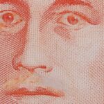 Close-up of a genuine S$10 note with Yusof Ishak moustache scraped off and eyelids scratched