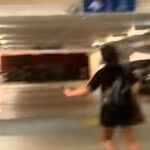 Video still of women confronting a man behind an HDB pillar in Sengkang
