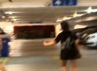 Video still of women confronting a man behind an HDB pillar in Sengkang