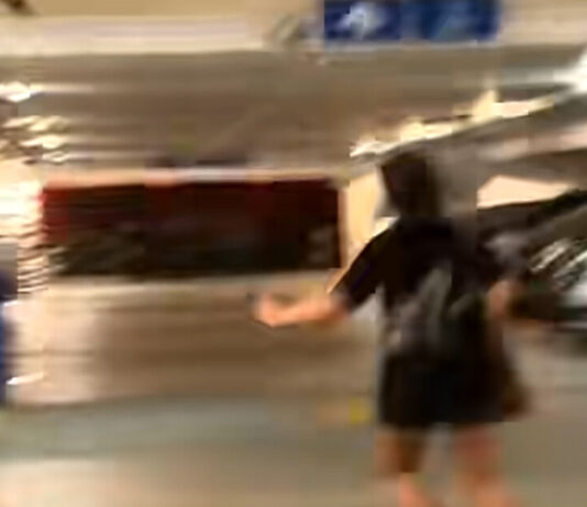 Video still of women confronting a man behind an HDB pillar in Sengkang