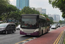 A Singapore public bus travelling in a dedicated red bus lane