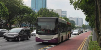 A Singapore public bus travelling in a dedicated red bus lane