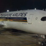 A Singapore Airlines aircraft at the gate, the kind of flight where smoking in the toilet is banned
