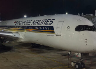 A Singapore Airlines aircraft at the gate, the kind of flight where smoking in the toilet is banned