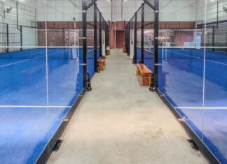 Singapore Man Says He Put S$368,000 Into Indonesian Sports-Gear Business and Fears Losing S$157,000 Empty indoor padel courts with blue turf and glass walls, non-literal stock for a sports-gear investment dispute