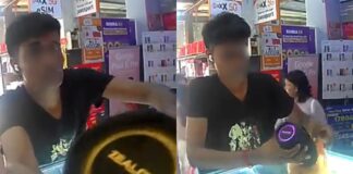 CCTV still of man allegedly taking speaker from Bukit Batok phone shop counter