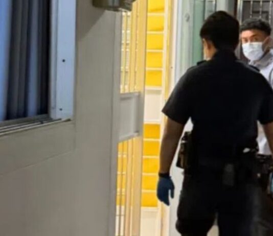 Singapore Man, 69, Found Dead Alone in Ubi Flat a Month After Son Went Overseas to Study Police officers at open unit doorway along HDB corridor in Ubi for elderly man found dead alone story