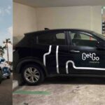 GetGo carsharing cars, including a blue Suzuki Swift and a branded Honda in a carpark