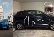 GetGo Users Can Now Drive Rental Cars Into Malaysia Without Visiting Rental Shops GetGo carsharing cars, including a blue Suzuki Swift and a branded Honda in a carpark