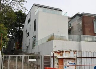 White Whitley Road bungalow under construction barriers involved in Kopitiam founder Lim Bee Huat contractor suit