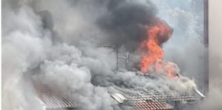 Simon Lane Kovan house fire with flames and smoke from roof