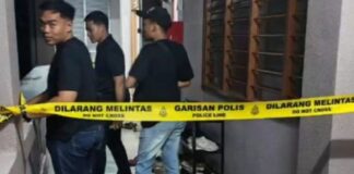 Malaysian police tape and investigators in a dormitory corridor in Dungun Terengganu