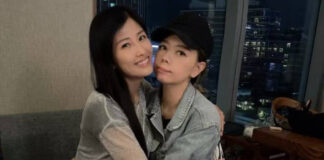 Margaret Chung, wearing a black cap and denim jacket, poses with a friend at a birthday gathering