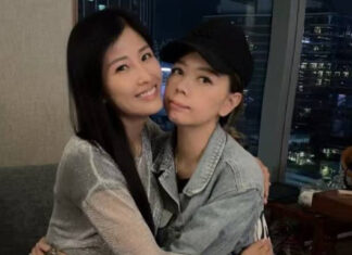 Margaret Chung, wearing a black cap and denim jacket, poses with a friend at a birthday gathering