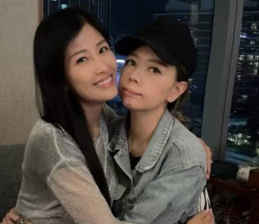 Margaret Chung, wearing a black cap and denim jacket, poses with a friend at a birthday gathering