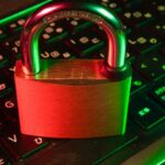 Payroll System Used by Singapore Mosques and Madrasahs Hit by Ransomware; Staff Data Potentially Compromised Padlock resting on a laptop keyboard representing ransomware and payroll data security