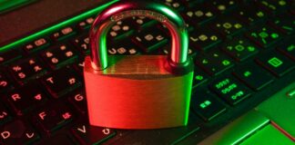Padlock resting on a laptop keyboard representing ransomware and payroll data security