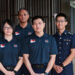 Singapore officers welcome-home / contingent photo or clearly non-literal disaster-relief stock (no wrong faces as named officers)
