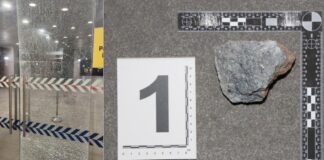 Shattered glass door at Police Cantonment Complex after rock-throwing vandalism incident