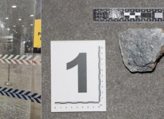 Shattered glass door at Police Cantonment Complex after rock-throwing vandalism incident