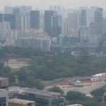 Hazy Singapore central skyline illustrating unhealthy air quality PSI levels