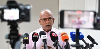 Senior Minister K Shanmugam speaking at a media doorstop after directing police to investigate racist online comments