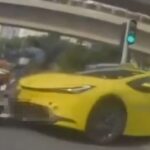 Dashcam still of yellow taxi colliding with motorcycle in Tampines