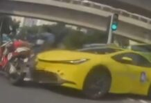 Female Motorcyclist, 30, Taken to Hospital After Taxi and 2 Motorcycles Collide in Tampines Dashcam still of yellow taxi colliding with motorcycle in Tampines