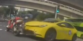 Dashcam still of yellow taxi colliding with motorcycle in Tampines