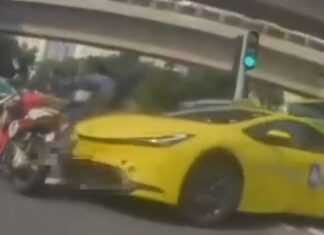 Dashcam still of yellow taxi colliding with motorcycle in Tampines
