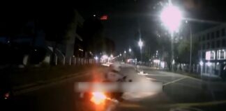 Dashcam still of Traffic Police motorcycle cutting in front of car near Ubi