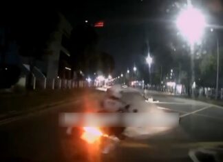 Dashcam still of Traffic Police motorcycle cutting in front of car near Ubi
