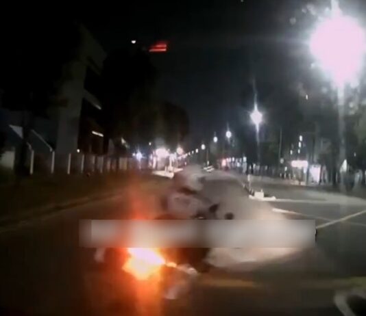 Dashcam still of Traffic Police motorcycle cutting in front of car near Ubi
