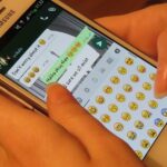 Person using a smartphone messaging app, illustrating a WhatsApp impersonation scam warning