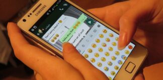 Person using a smartphone messaging app, illustrating a WhatsApp impersonation scam warning