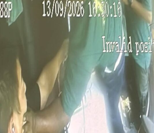 CCTV still of worker grabbing chartered bus driver Cai Zhi Feng by the face during workers brawl
