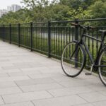 Empty Singapore shared path with an ordinary bicycle parked beside a railing, non-literal illustration with no people or accident scene