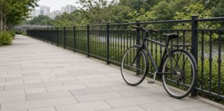 Empty Singapore shared path with an ordinary bicycle parked beside a railing, non-literal illustration with no people or accident scene