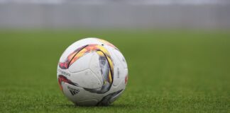 Football on a grass pitch (non-literal stock; match was in Bandung)