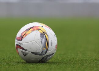 Football on a grass pitch (non-literal stock; match was in Bandung)