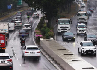 Cars driving along a wet expressway in Singapore