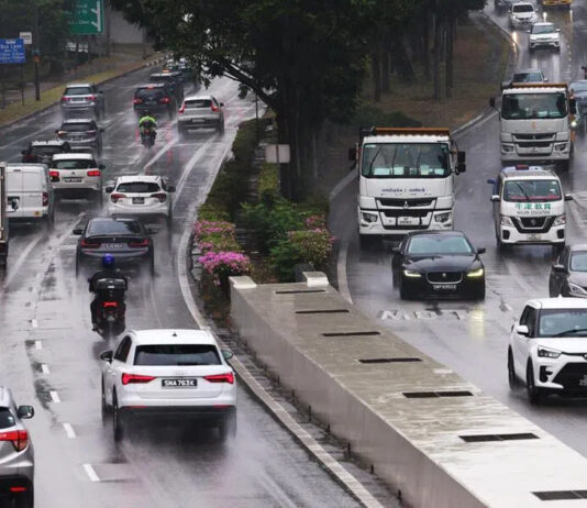 Cars driving along a wet expressway in Singapore