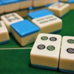 Mahjong tiles on a green felt table (non-literal stock)
