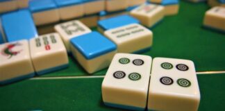 Mahjong tiles on a green felt table (non-literal stock)