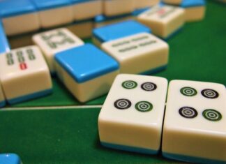 Mahjong tiles on a green felt table (non-literal stock)